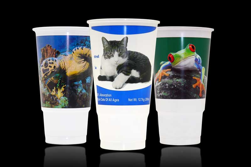 Plastic cups with animal images on black.