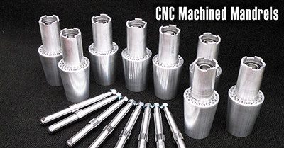 CNC machined mandrels on black background.
