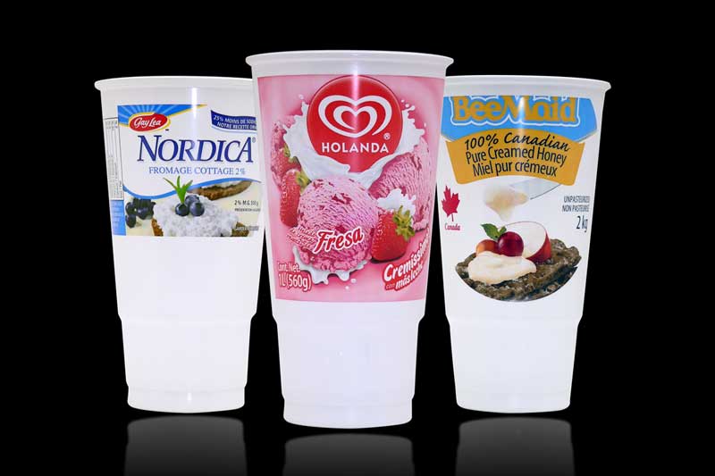 Three branded food containers on black background.