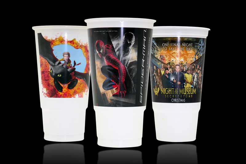 Three movie-themed collectible cups on display.