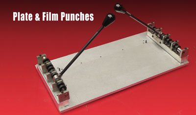 Plate and film punches on red background.